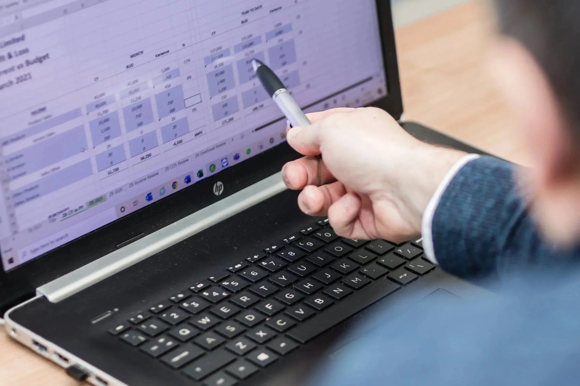 Close up image of SyPro Managing Director, Ryan Wakeman reviewing a spreadsheet of data